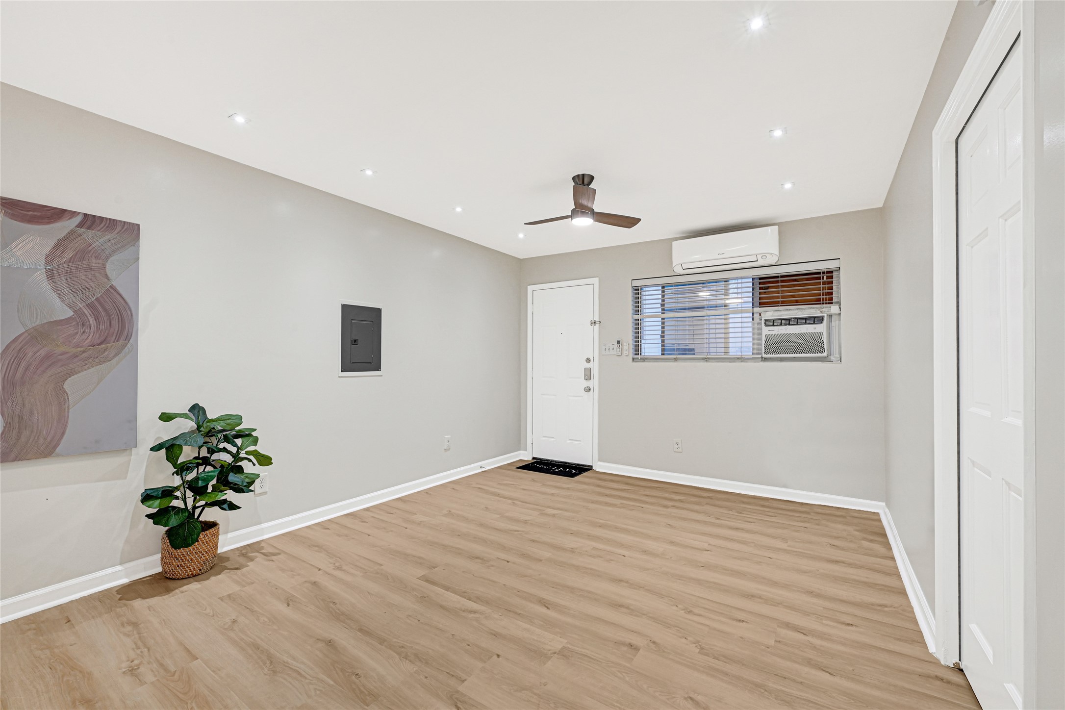 1603 Welch Street, Unit 8 Houston, TX 77006 - Photo 12 of 21 a view of an empty room with wooden floor and a potted plant
