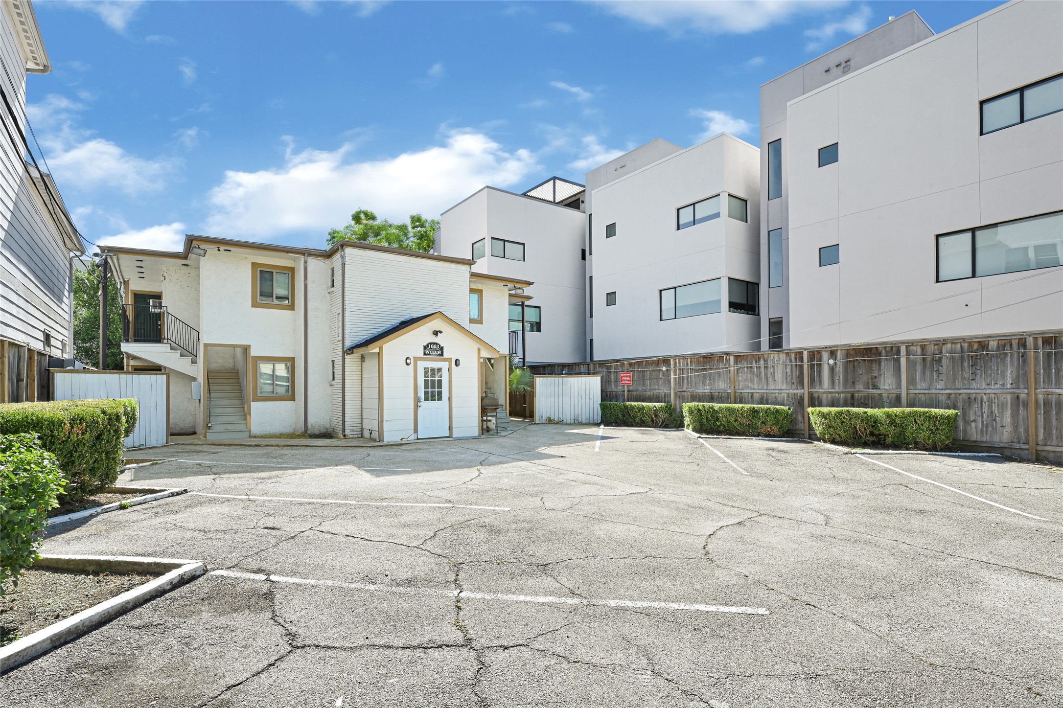 1603 Welch Street, Unit 8 Houston, TX 77006 - Photo 4 of 21 a front view of a house with a yard and garage