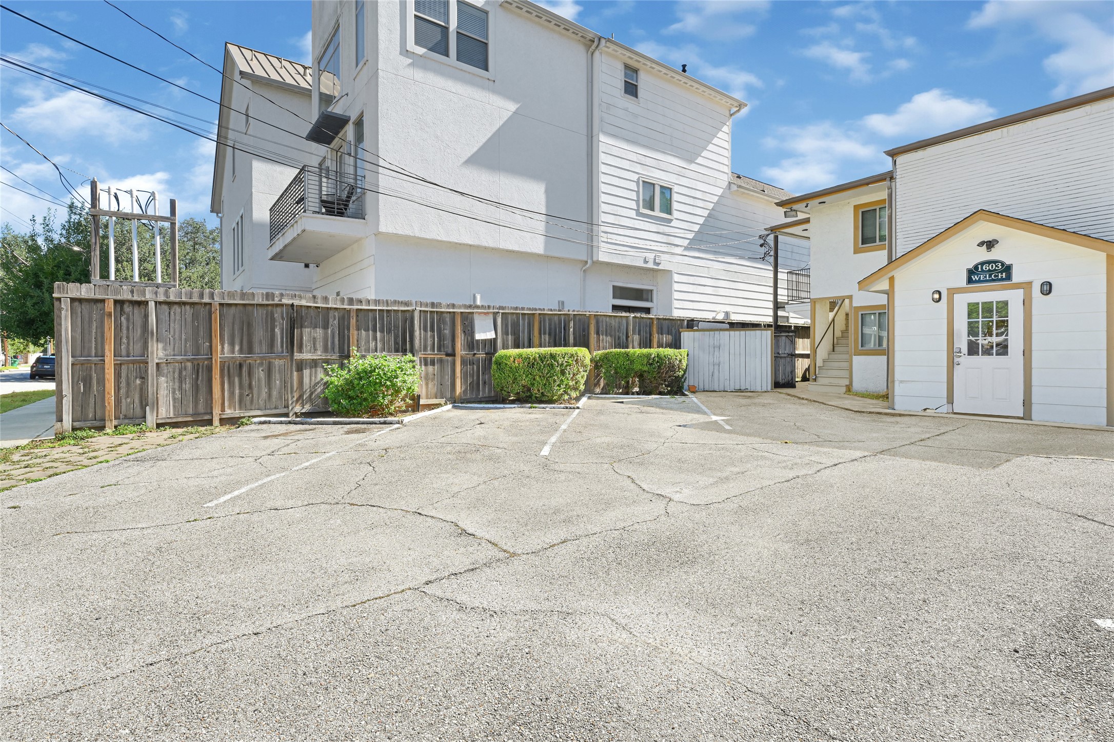 1603 Welch Street, Unit 8 Houston, TX 77006 - Photo 5 of 21 a view of a white house next to a yard