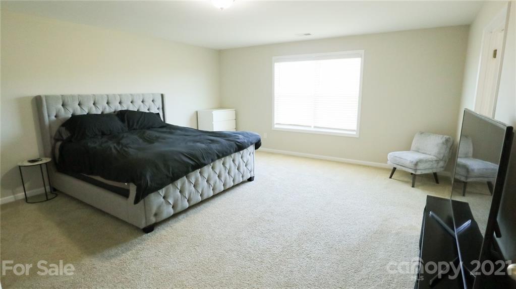 1437 Bramblewood Drive Fort Mill, SC 29708 - Photo 15 of 22 a bedroom with a bed and a chair
