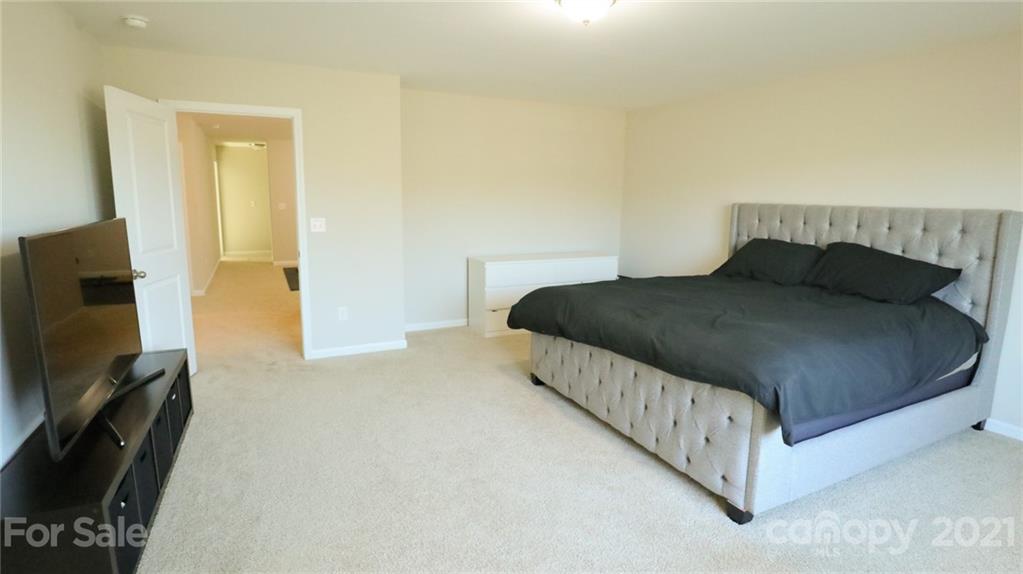 1437 Bramblewood Drive Fort Mill, SC 29708 - Photo 16 of 22 a bedroom with a bed and a flat screen tv