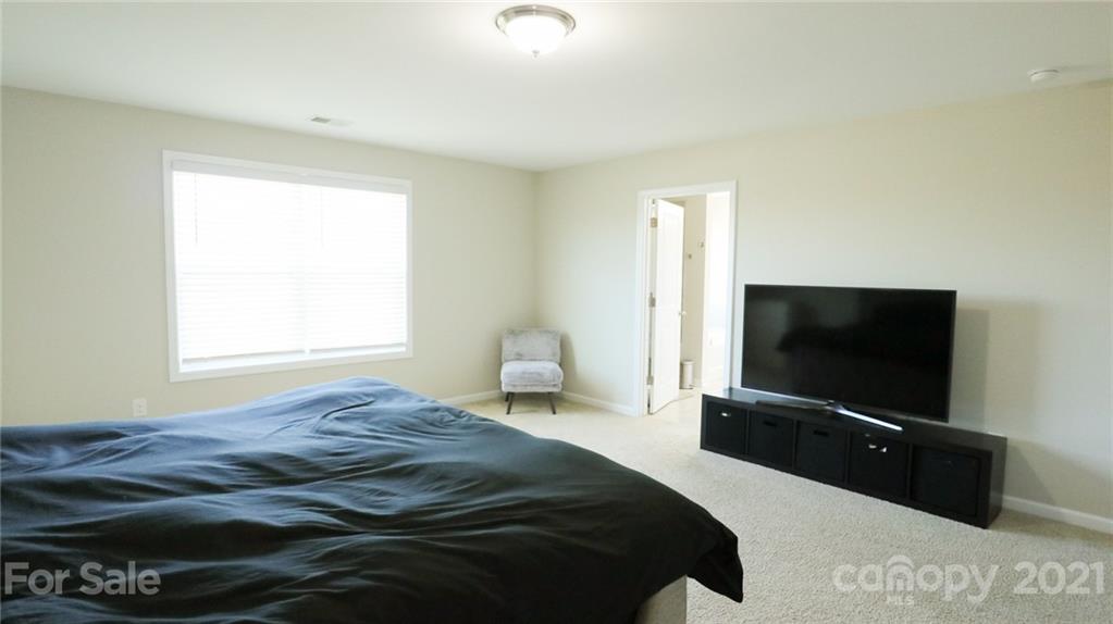 1437 Bramblewood Drive Fort Mill, SC 29708 - Photo 17 of 22 a bedroom with a bed and a flat screen tv