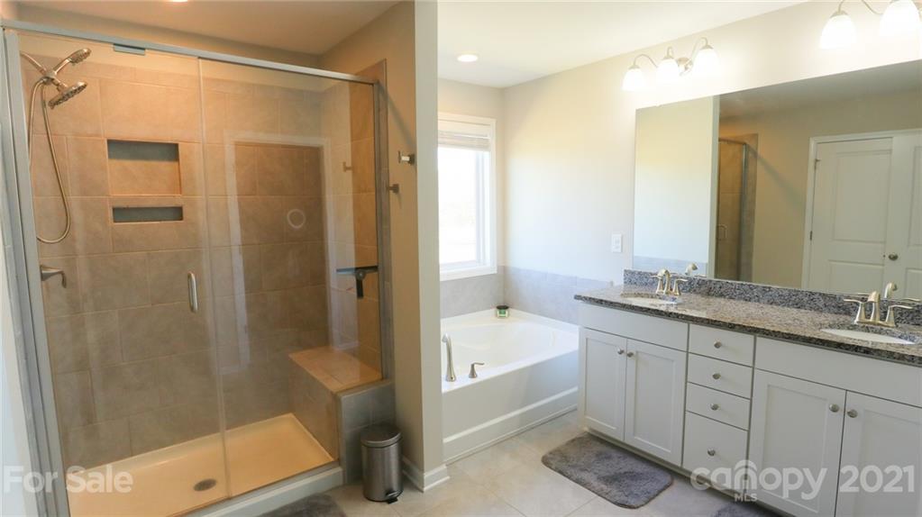 1437 Bramblewood Drive Fort Mill, SC 29708 - Photo 18 of 22 a bathroom with a granite countertop sink a toilet and shower