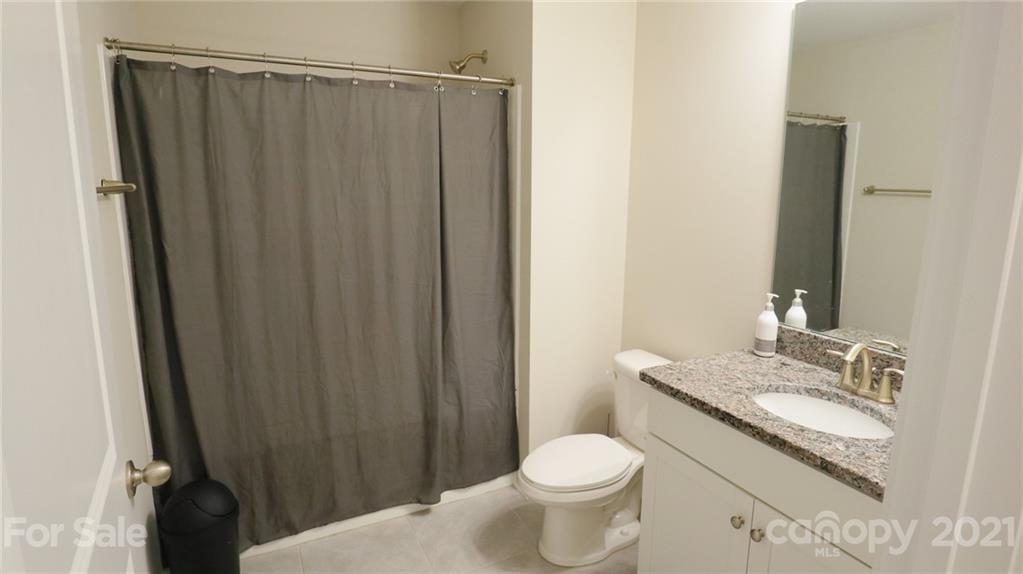 1437 Bramblewood Drive Fort Mill, SC 29708 - Photo 19 of 22 a bathroom with a granite countertop sink toilet and a mirror
