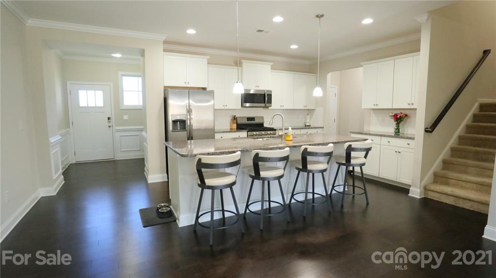 1437 Bramblewood Drive Fort Mill, SC 29708 - Photo 8 of 22 a view of a dining room with furniture wooden floor and a kitchen