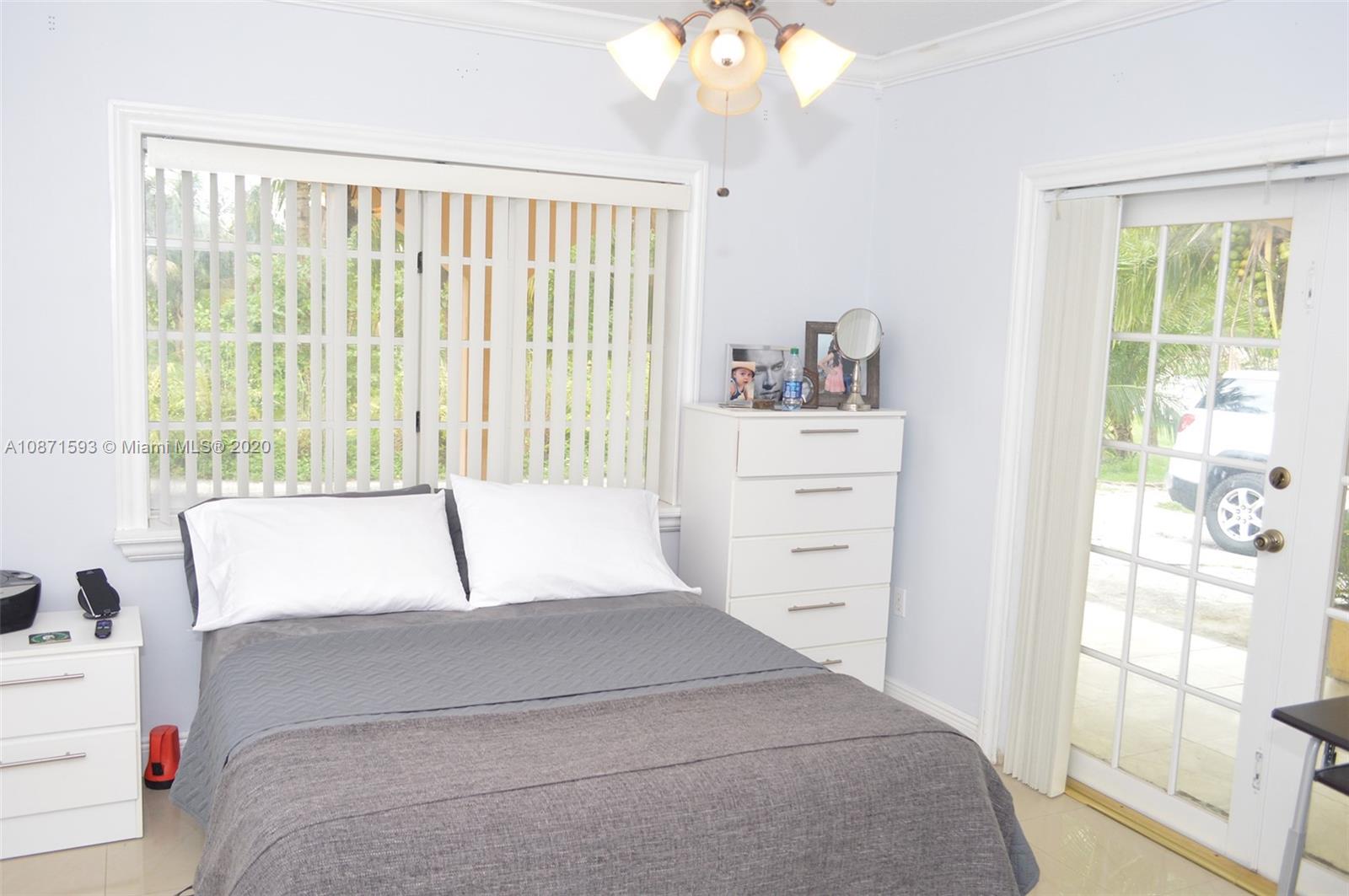 6500 Southwest 148th Avenue Southwest Ranches, FL 33330 - Photo 12 of 25 a bedroom with a bed and a window