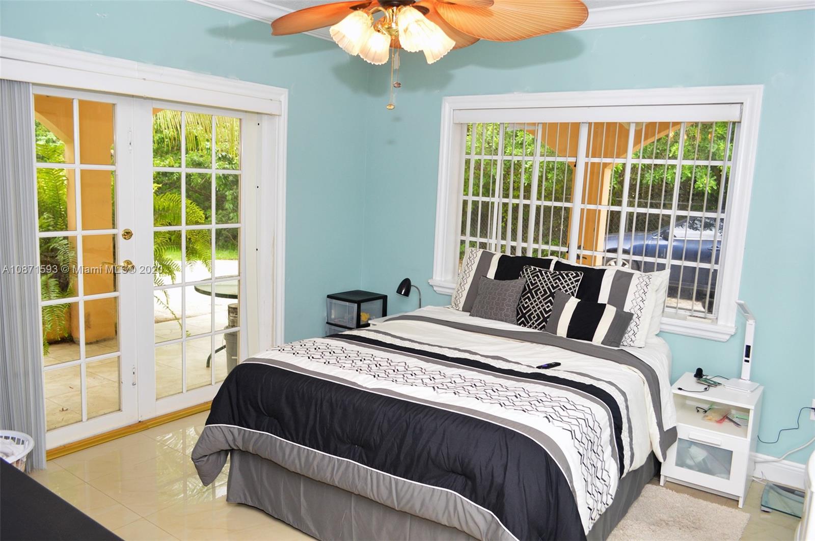 6500 Southwest 148th Avenue Southwest Ranches, FL 33330 - Photo 14 of 25 a bed sitting in a bedroom next to a window