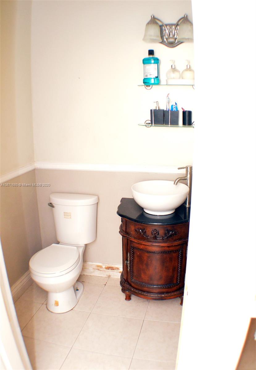 6500 Southwest 148th Avenue Southwest Ranches, FL 33330 - Photo 16 of 25 a toilet sitting next to a white sink