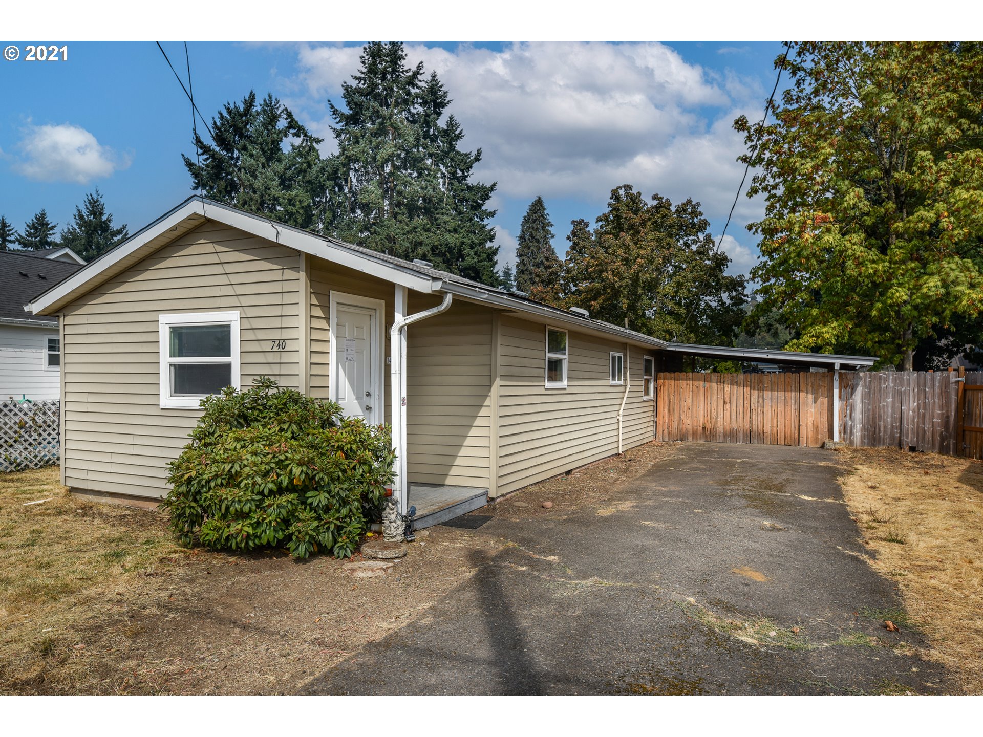 740 West M Street Springfield, OR 97477 - Photo 1 of 23 a backyard of a house with plants and trees