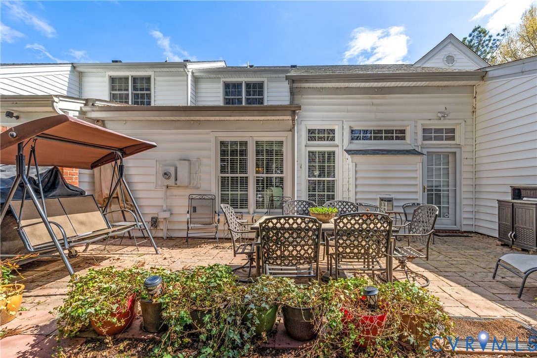 2205 Magnolia Grove Way Midlothian, VA 23113 - Photo 36 of 37 a view of a patio with table and chairs and potted plants
