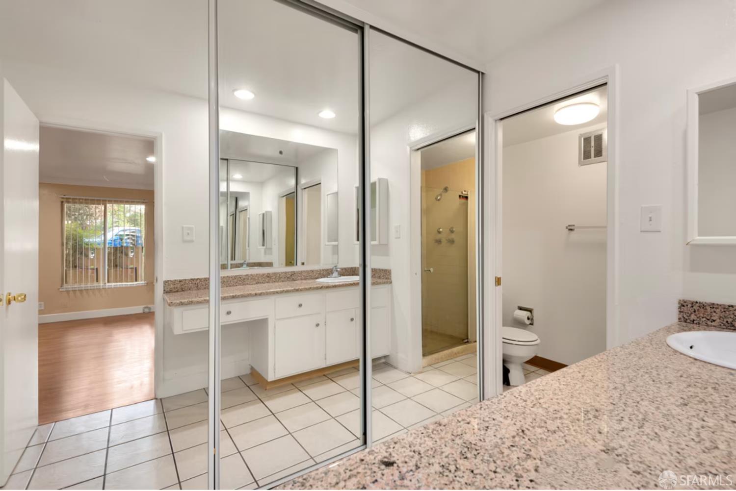 1736 Woodland Avenue Palo Alto, CA 94301 - Photo 12 of 17 a bathroom with a granite countertop sink mirror and shower