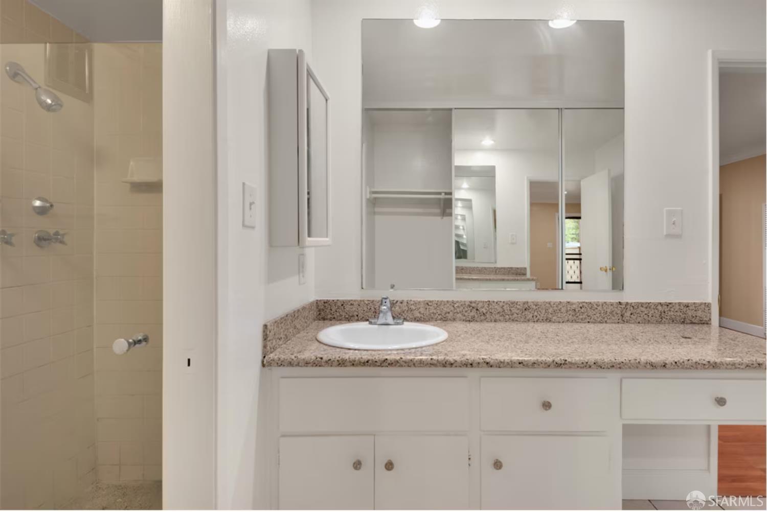 1736 Woodland Avenue Palo Alto, CA 94301 - Photo 14 of 17 a bathroom with a granite countertop sink and a mirror