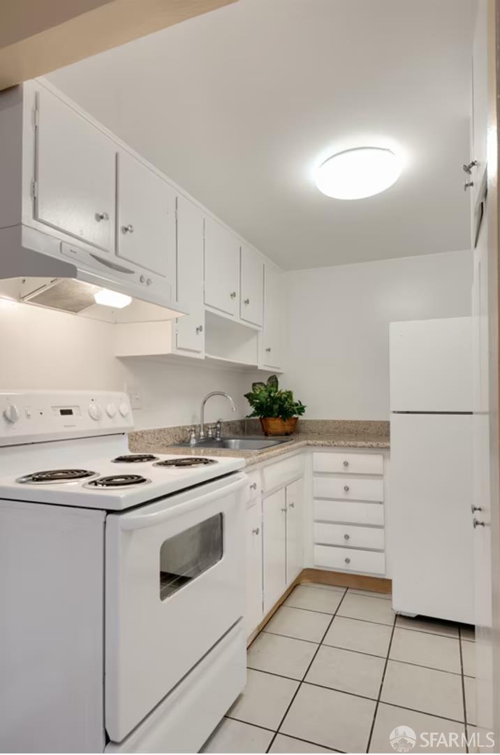 1736 Woodland Avenue Palo Alto, CA 94301 - Photo 6 of 17 a kitchen with granite countertop white cabinets and white appliances