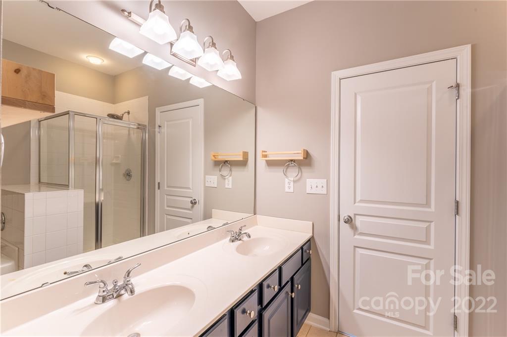 3941 Caliper Place Fort Mill, SC 29708 - Photo 19 of 46 a bathroom with a sink vanity granite and a mirror