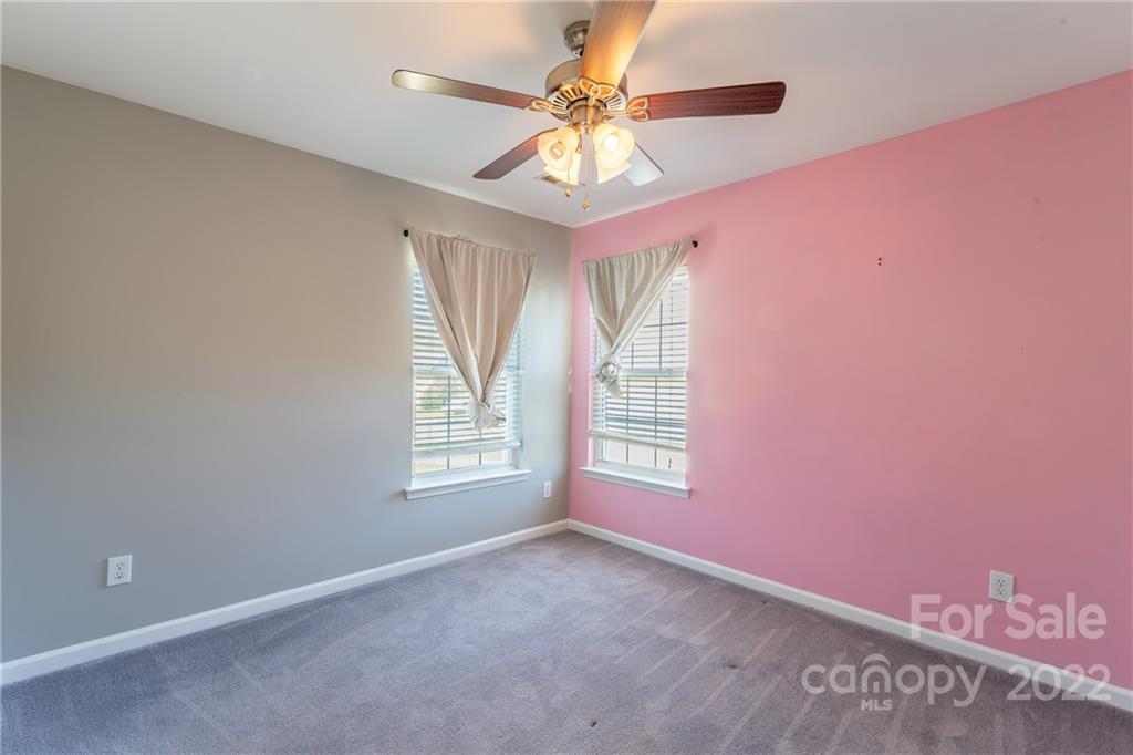 3941 Caliper Place Fort Mill, SC 29708 - Photo 30 of 46 an empty room with windows and chandelier fan