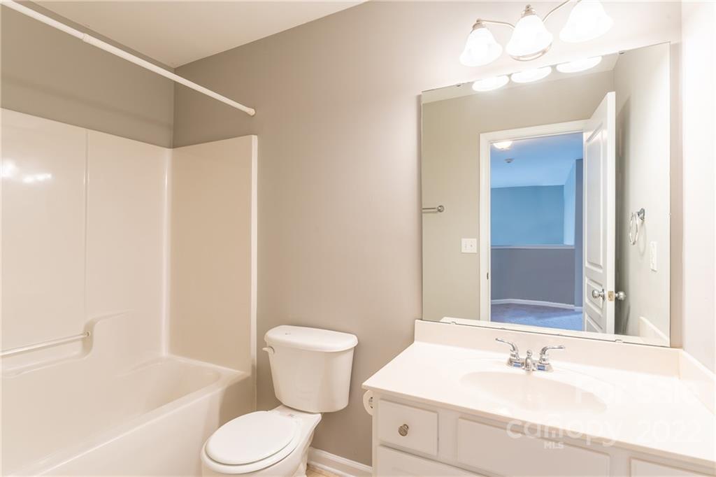 3941 Caliper Place Fort Mill, SC 29708 - Photo 36 of 46 a bathroom with a sink toilet a mirror and vanity
