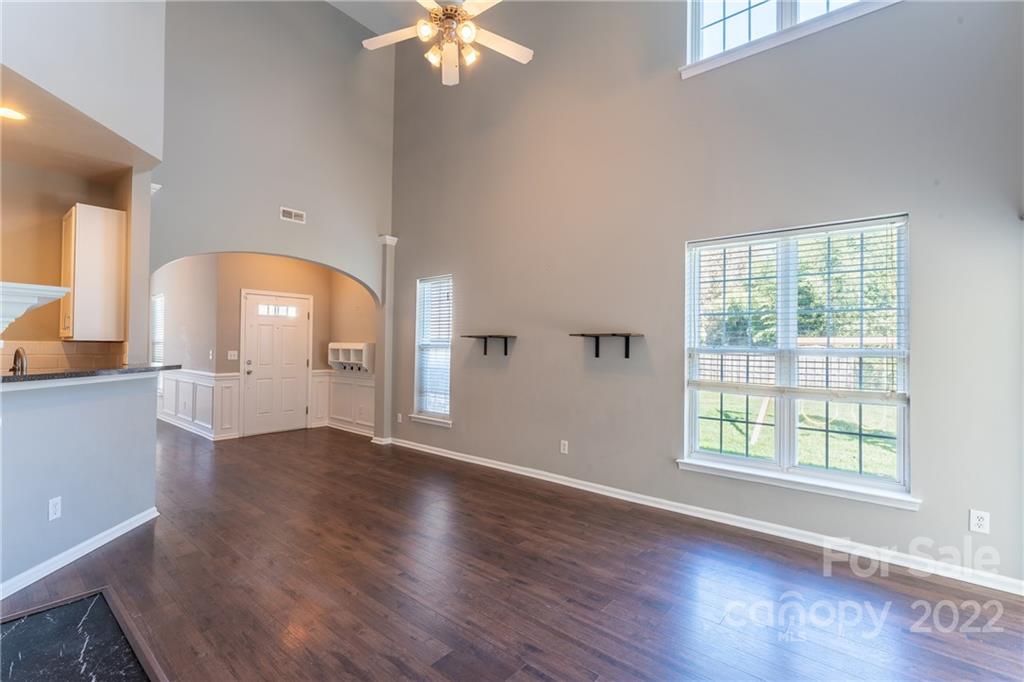3941 Caliper Place Fort Mill, SC 29708 - Photo 6 of 46 an empty room with wooden floor and windows