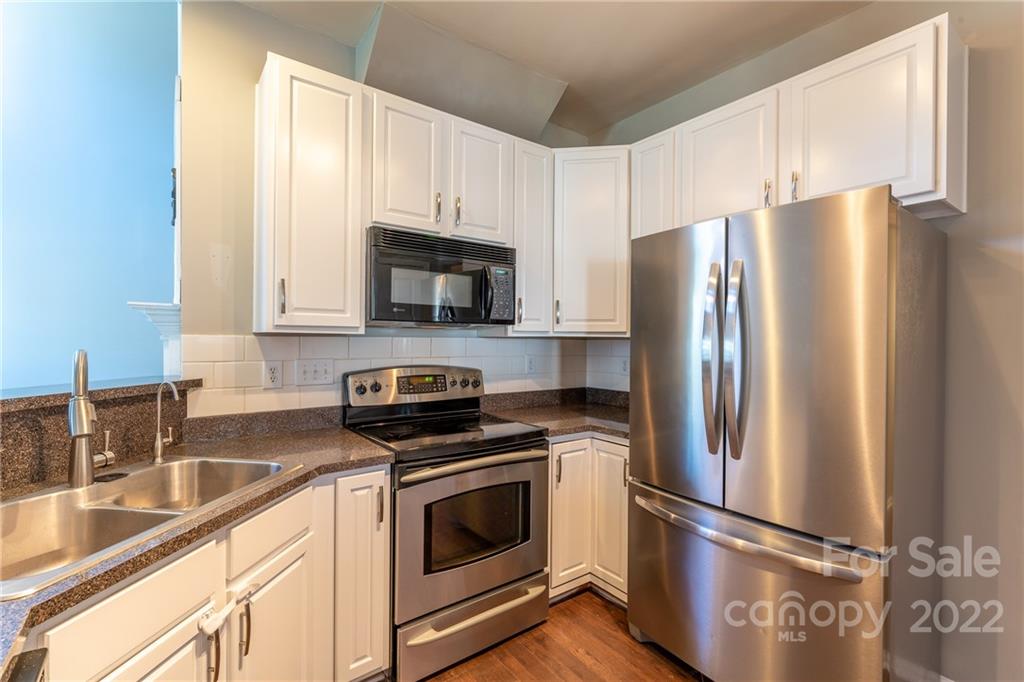3941 Caliper Place Fort Mill, SC 29708 - Photo 7 of 46 a kitchen with stainless steel appliances a refrigerator sink and microwave