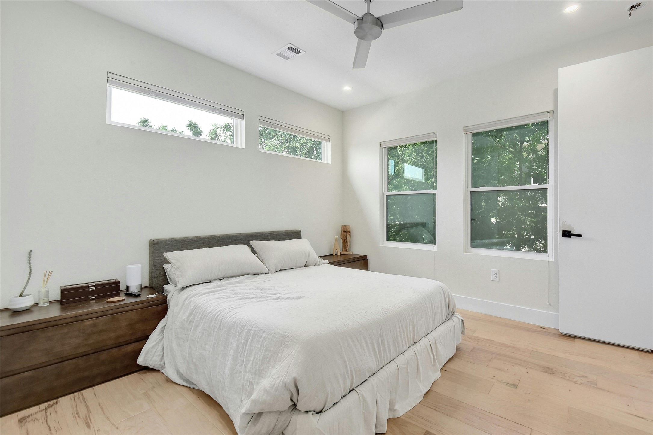 4606 Ledesma Road, Unit 2 Austin, TX 78721 - Photo 17 of 33 Hardwood floors and a ceiling fan cool this minimalist sleeping sanctuary.
