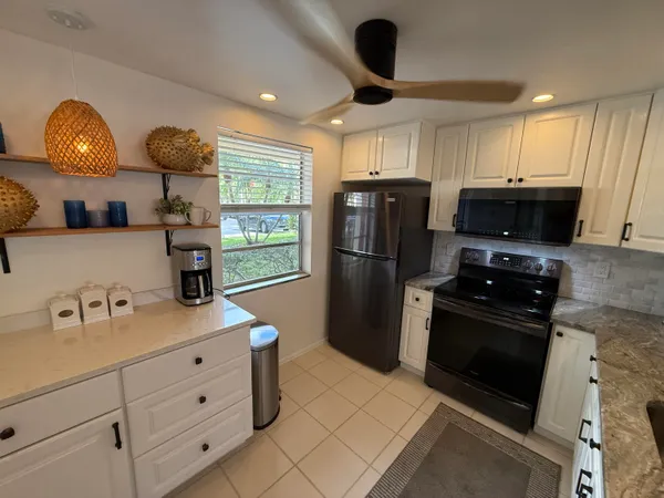 a view of a dining room with furniture a chandelier and wooden floor
