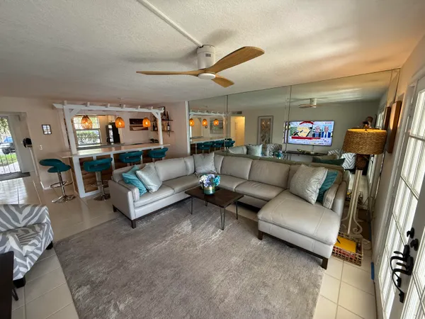 a living room with furniture and a floor to ceiling window