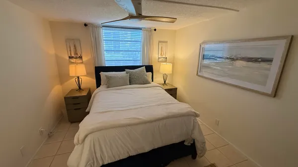 a bedroom with a bed and a mirror