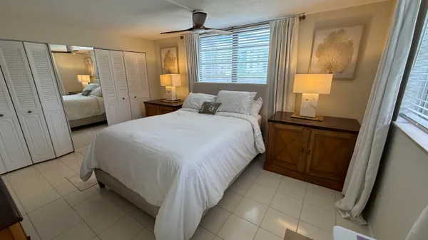 a bedroom with a bed chair and window