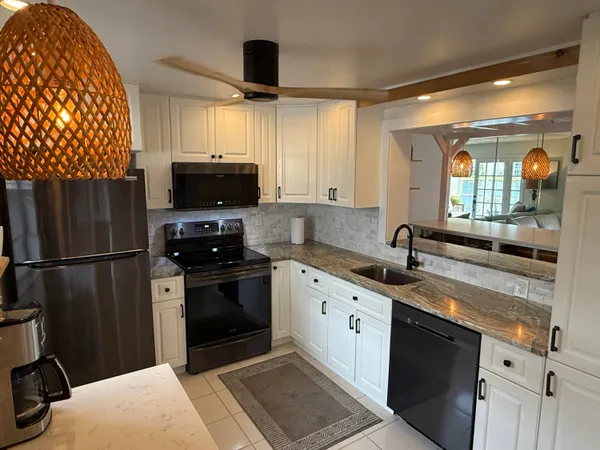 a kitchen with stainless steel appliances a refrigerator a stove a sink and a refrigerator