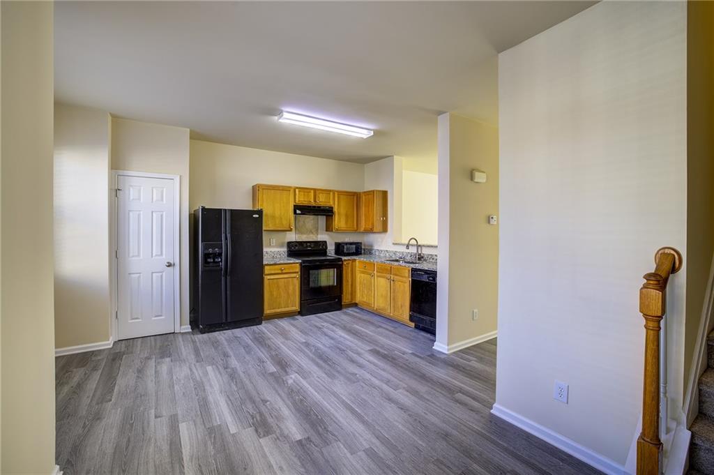 2247 Landing Ridge Drive Duluth, GA 30097 - Photo 12 of 24 a kitchen with stainless steel appliances a refrigerator and wooden floor