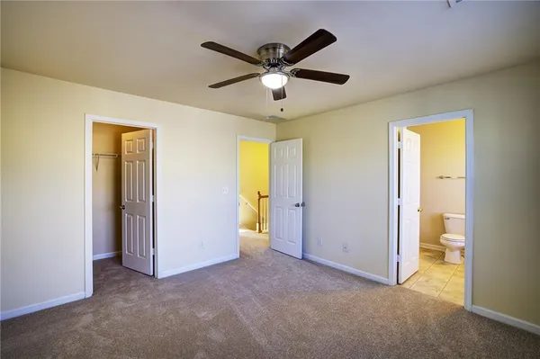 a view of a room with a ceiling fan