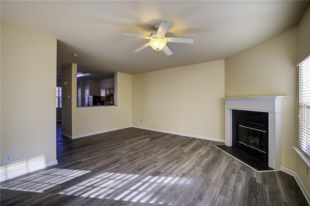2247 Landing Ridge Drive Duluth, GA 30097 - Photo 8 of 24 wooden floor in an empty room with a fireplace and a window