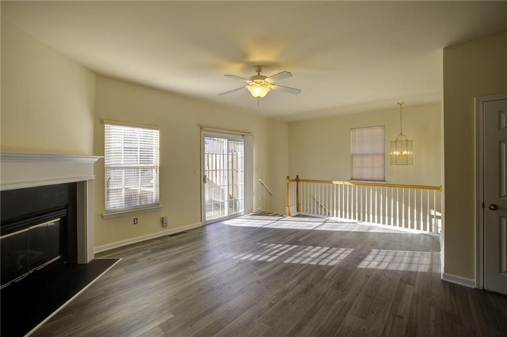 2247 Landing Ridge Drive Duluth, GA 30097 - Photo 9 of 24 an empty room with wooden floor fireplace and windows