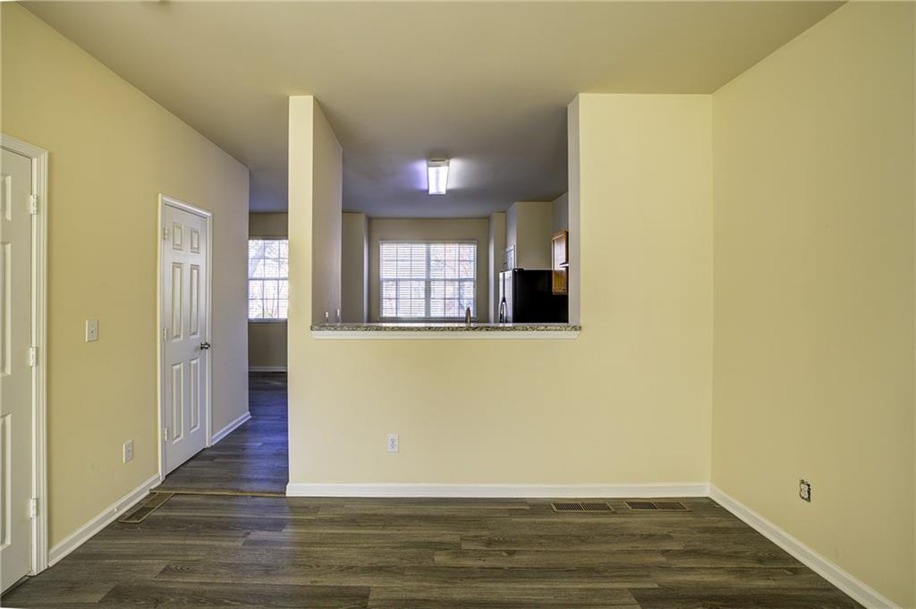 2247 Landing Ridge Drive Duluth, GA 30097 - Photo 10 of 24 a view of an empty room with wooden floor and a window