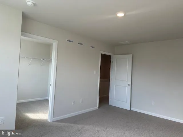an empty room with closet area