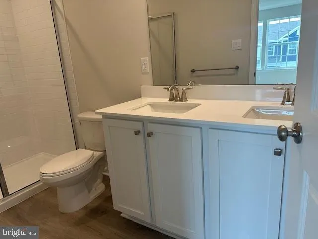 a bathroom with a sink toilet and mirror