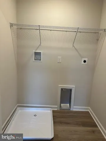 a view of a room with wooden floor and fan