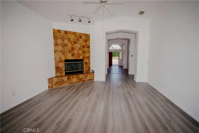 wooden floor fireplace and windows in a room