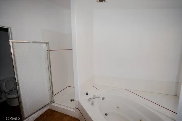 a bathroom with a bathtub and a shower
