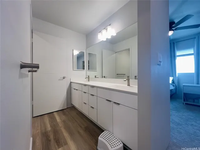a bathroom with a double vanity sink and mirror