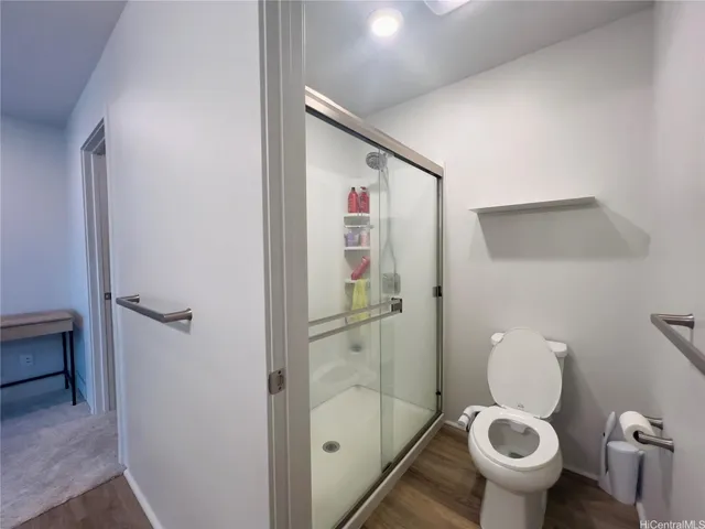 a bathroom with a toilet and a shower
