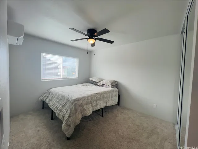 a spacious bedroom with a bed and a chandelier