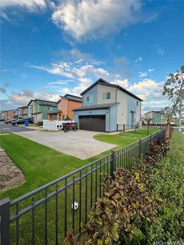 a view of a house with a big yard plants and large trees