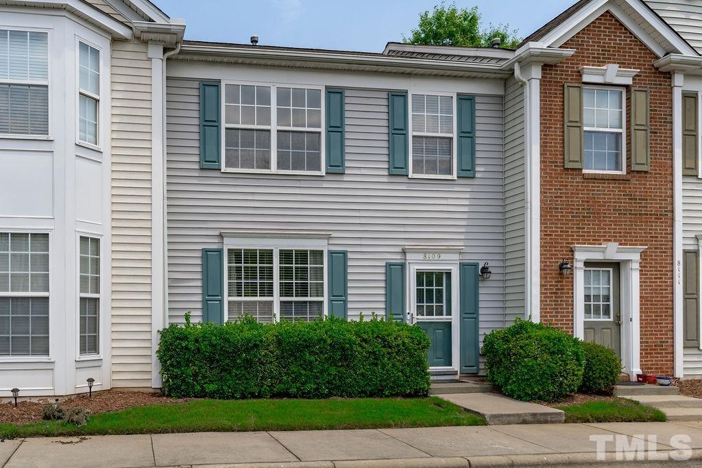8109 Rhiannon Road Raleigh, NC 27613 - Photo 1 of 11 a front view of a house with a yard and plants