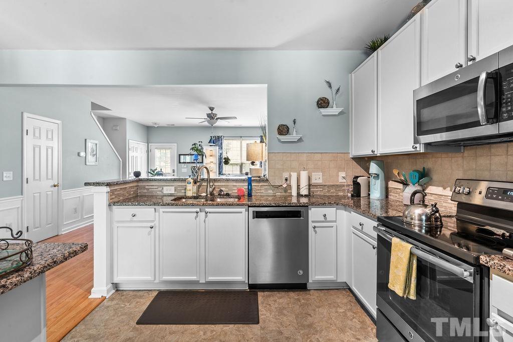 8109 Rhiannon Road Raleigh, NC 27613 - Photo 5 of 11 a kitchen with granite countertop stainless steel appliances and sink