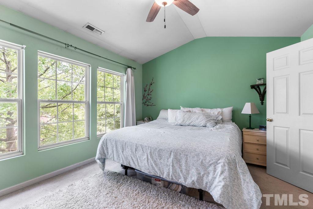 8109 Rhiannon Road Raleigh, NC 27613 - Photo 9 of 11 a bedroom with a bed and a window