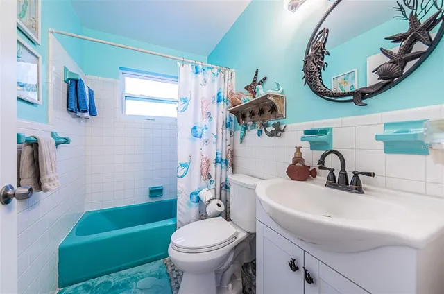 a bathroom with a sink mirror toilet and bathtub