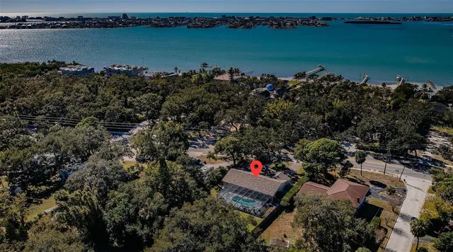 an aerial view of a residential house with outdoor space and lake view