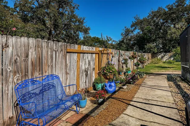 a backyard of a house with barbeque oven table and chairs