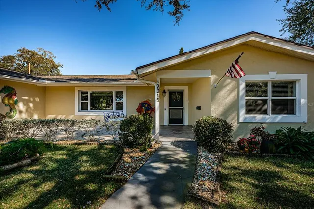a front view of house with yard and outdoor seating