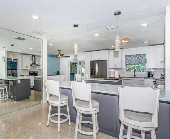 a kitchen with a dining table chairs and microwave